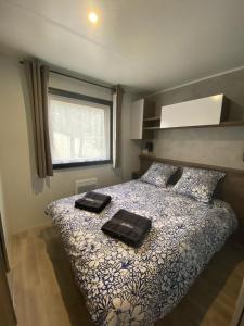 Un dormitorio con una cama con dos bolsas negras. en A la brise du Ferret, en Lège-Cap-Ferret