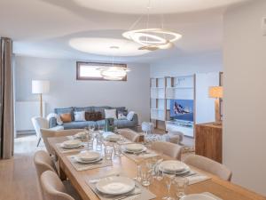a dining room with a table and chairs at Duplex neuf proche pistes avec Wifi et parking - FR-1-645-58 in LʼHuez
