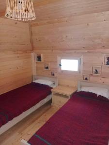 a room with two beds in a log cabin at Katun Siska Medna Dolina in Berane