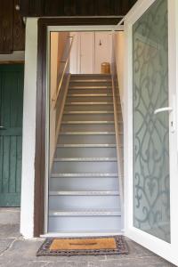 a set of stairs leading up to a door at New, quiet apartment close to Basel in Saint-Louis