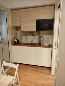 a small kitchen with a sink and a microwave at B&B Confort in Reggio di Calabria