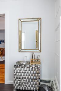 a mirror on a wall above a vanity in a room at Private Village Home in Catskill Splendor in Catskill