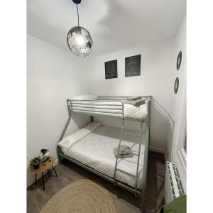 a bunk bed in a room with a lamp at La Casa del Barco del Humo in Vigo