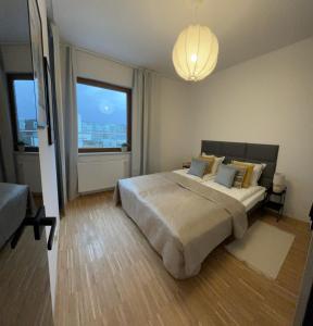 a bedroom with a large bed and a large window at Altoria Active Gdynia in Gdynia