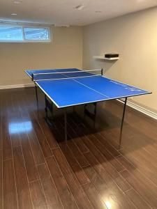 a blue ping pong table in an empty room at Enjoy luxury living in Mississauga