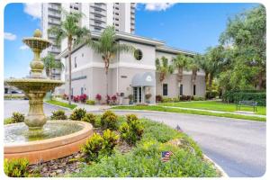 a large building with a fountain in front of a building at Scenic View Condo Near Disney in Orlando