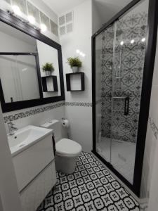 a bathroom with a toilet and a sink and a shower at Apartment Barca 1 Camp Nou in Barcelona