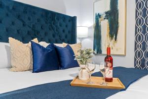 a tray with a bottle of wine and glasses on a bed at Scenic View Condo Near Disney in Orlando +28 photos