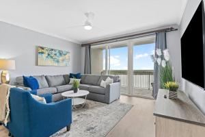 a living room with a couch and a tv at Scenic View Condo Near Disney in Orlando