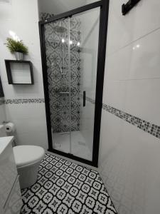 a bathroom with a toilet and a glass shower at Apartment Barca 1 Camp Nou in Barcelona