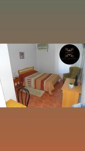 a small bedroom with a bed and a table at Hotel COSTAS in Fortuna
