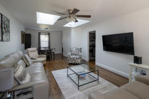 a living room with a couch and a flat screen tv at 3Bed City Ranch near DTR in Raleigh