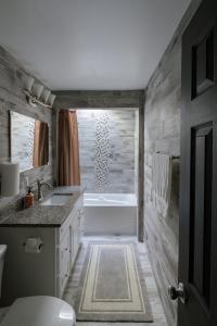a bathroom with a tub and a toilet and a sink at 3Bed City Ranch near DTR in Raleigh