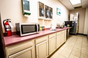 a kitchen with a pink counter top with a microwave at Manistee Inn & Marina in Manistee