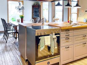 a kitchen with an island with a stove top oven at Holiday home ONSALA VI in Onsala