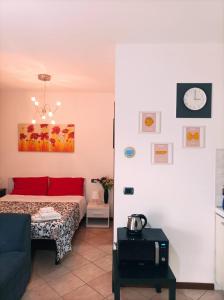 a bedroom with a bed and a couch in a room at Casa Angela Parma in Parma