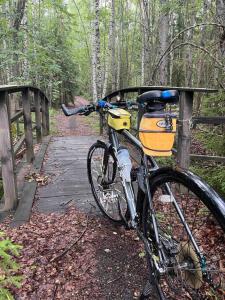 a bike parked next to a wooden bridge at Lammastilan laavu - Lean to Inarin tila in Salo