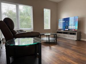 a living room with a couch and a flat screen tv at Luxury Downtown Townhome Unit 7 in Cleveland