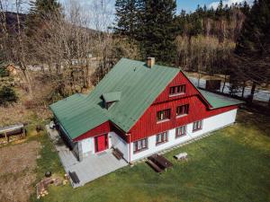 an overhead view of a red barn with a green roof at Turistická chata TJ TESLA BRNO in Ostružná