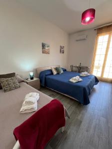 a bedroom with two beds and a red light at Borgo Levano in Licata