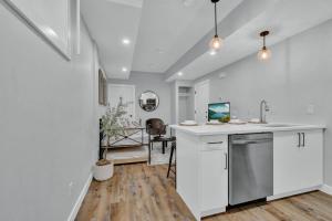 a kitchen with white cabinets and a counter top at Stylish Suite-NearWEM-4 Bed-Central in Edmonton