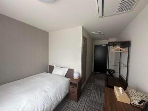 Postel nebo postele na pokoji v ubytování WORLD ASAHI HOTEL