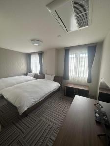 Postel nebo postele na pokoji v ubytování WORLD ASAHI HOTEL
