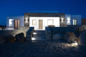 a house with stairs in front of it at night at Maistros Apartments Mykonos in Elia