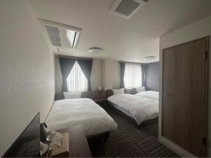Postel nebo postele na pokoji v ubytování WORLD ASAHI HOTEL