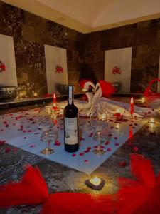 a bottle of wine sitting on a table with wine glasses at SİVAS AZZE PALACE OTEL in Sivas