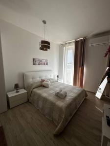 a bedroom with a bed with two towels on it at Bella Puglia Bed and Breakfast in Ruvo di Puglia