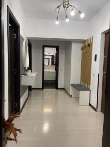 an empty hallway with a sink and a mirror at Dem ‘LuxuryApartmens in Râmnicu Vâlcea