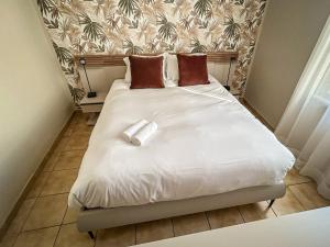 a large white bed with two pillows on it at La maison des Cordeliers in Loches