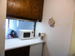 a kitchen with a microwave on a counter at Résidence Bionnassay - Bionnassay B159 MAE-5357 in Les Contamines-Montjoie