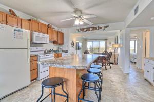 a kitchen with a large island with bar stools at DL104 Dunes Watch Oceanfront in Nags Head