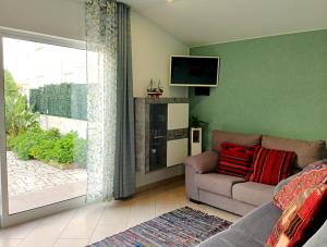 a living room with a couch and a tv on the wall at Wonder Villa in Albufeira