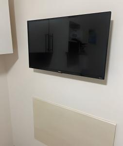 Una televisión o centro de entretenimiento en Apartamento 2 quartos c/ garagem