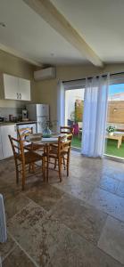 a kitchen with a table and chairs and a kitchen with a window at Chez Lisa in Saint-Louis-du-Rhône