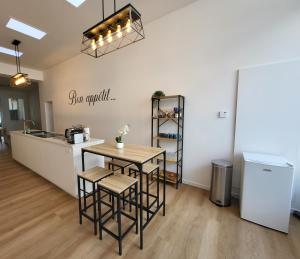 a kitchen with a table and stools in a room at Private rooms - European Quarter in Brussels