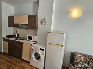 a kitchen with a refrigerator and a washing machine at Europroperties Yalta Apartments in Golden Sands
