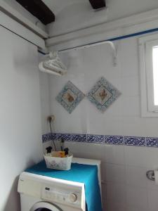 a laundry room with a washing machine and a window at Penthouse Pza España - 4th Floor in Barcelona