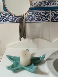 a candle sitting on top of a bathroom sink at Penthouse Pza España - 4th Floor in Barcelona