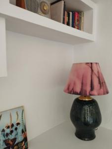 a lamp sitting on a table next to a book shelf at Penthouse Pza España - 4th Floor in Barcelona