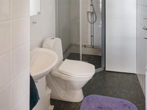 a bathroom with a toilet and a sink at Holiday home FäRENTUNA in Kungsberga