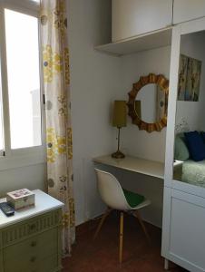 a bedroom with a desk and a chair and a mirror at Penthouse Pza España - 4th Floor in Barcelona