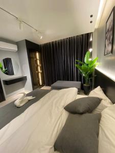 San Vito Luxury apartment في السويمة: غرفة نوم بسرير ابيض كبير مع مخدات