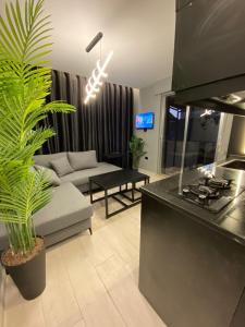 a living room with a couch and a table at San Vito Luxury apartment in Sowayma