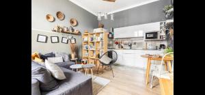 a living room with a couch and a kitchen at COCOON, Iconic Design in Historic Center & Breakfast in Sarzana