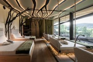 a bedroom with four beds and a large window at Viktoria Alpine Hideaway in Avelengo +88 photos