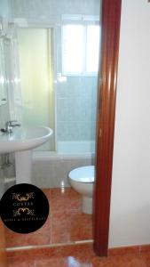 a bathroom with a sink and a toilet and a shower at Hotel COSTAS in Fortuna